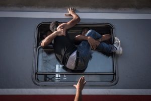 Sergey Ponomarev "Desperate refugees board the train toward Zagreb at Tovarnik station on the Serbian border"